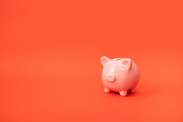 Premium Photo | Pig piggy bank with copyspace on a red background