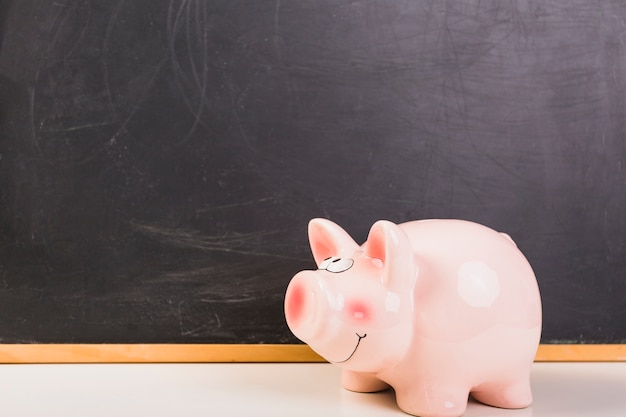 Piggy bank placed at chalkboard Free Photo