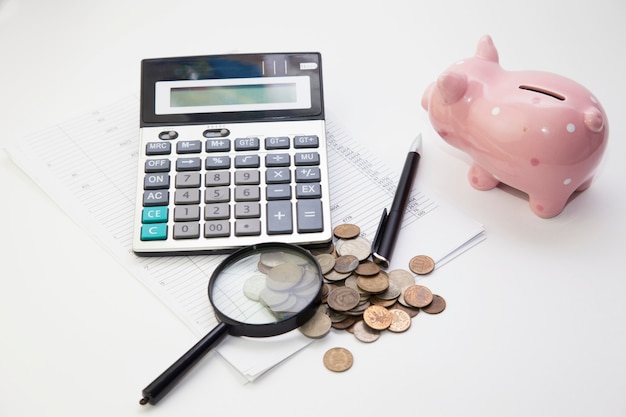 Premium Photo | Piggy bank with coins and calculator