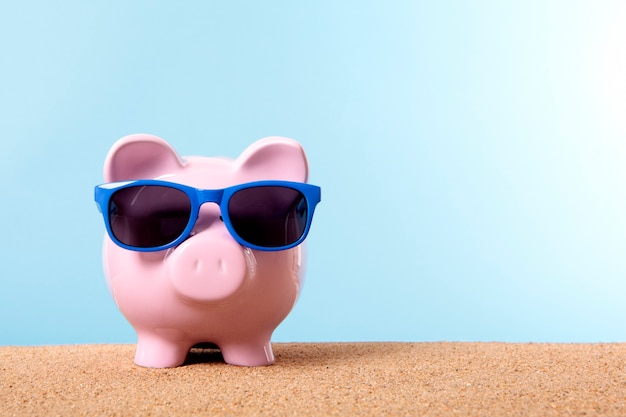 Piggybank with blue sunglasses Free Photo