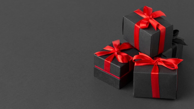 Free Photo | Pile of black wrapped gifts copy space