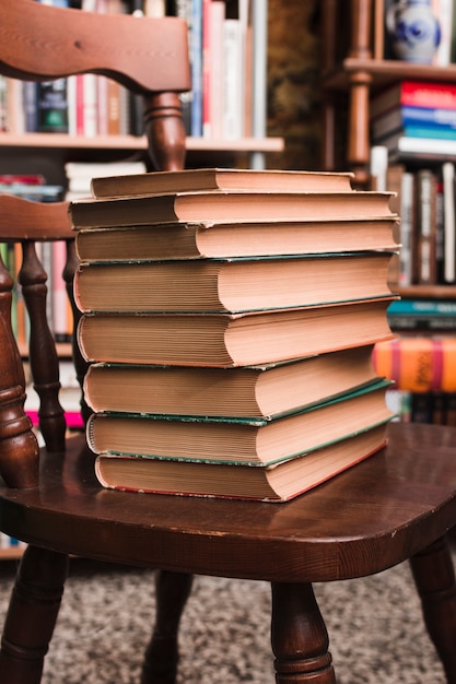 Free Photo | Pile of books on a chair