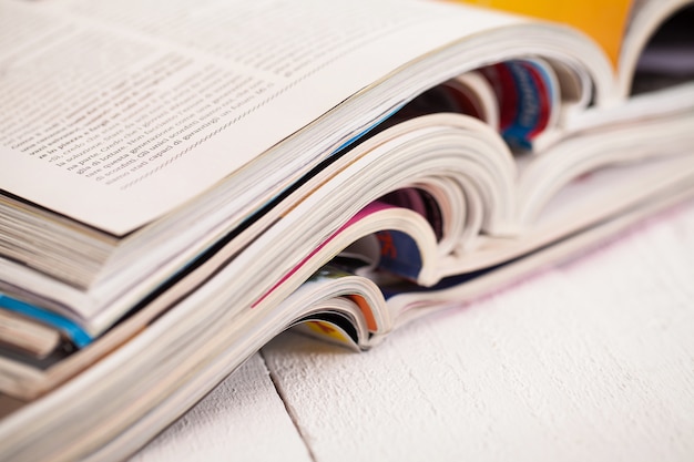 Pile of colorful magazines on a table | Free Photo