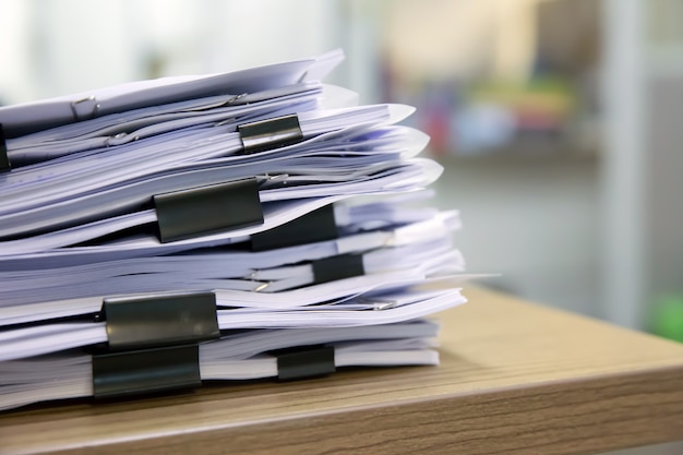 Premium Photo | Pile of documents stack up on the table.