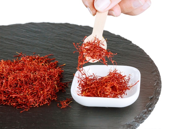 Premium Photo | Pile of dry saffron threads on a black textured