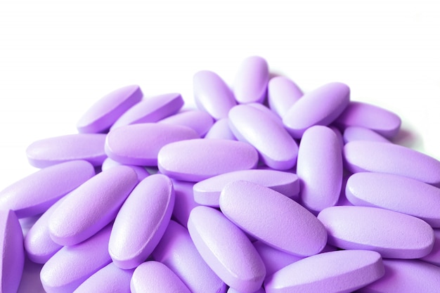 Premium Photo Pile Of Lilac Purple Color Oval Shaped Supplement Pills