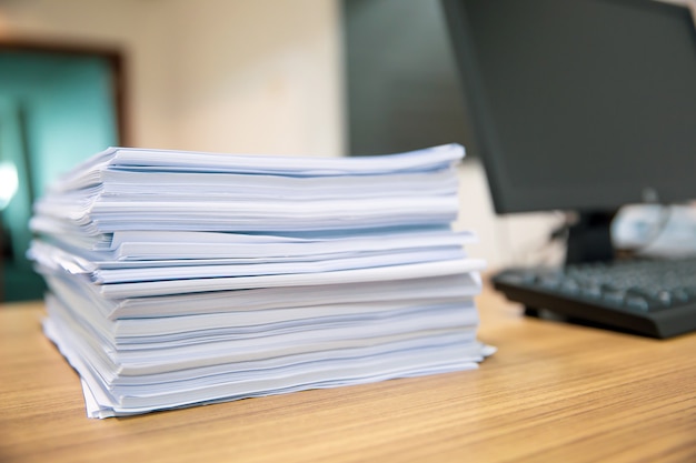 Premium Photo | Pile of a paper on office desk stacked.