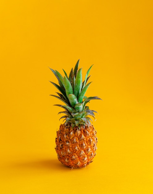 Premium Photo | Pineapple on a yellow background