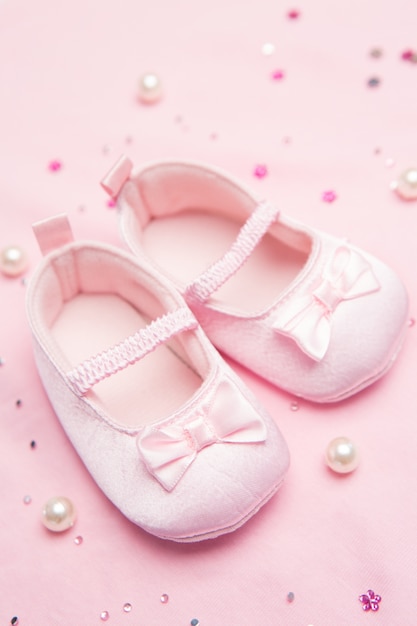 Premium Photo | Pink baby shoes for a girl