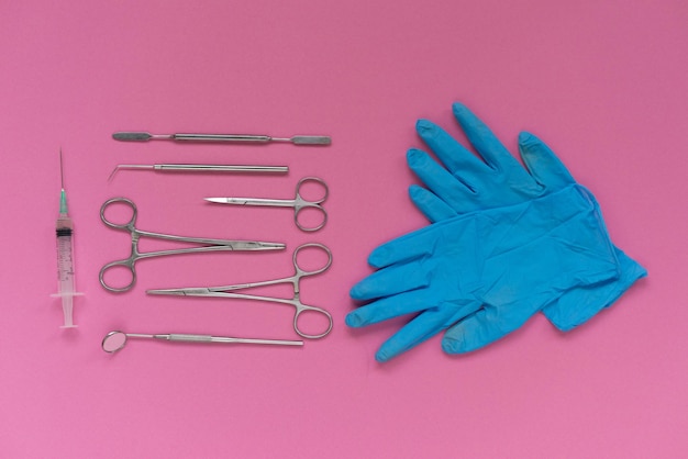 Premium Photo | On a pink background is a surgical toolkit and medical ...