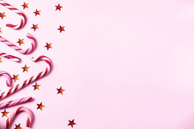 Download Free Pink Background With Christmas Candy Canes Shining Red Stars And Use our free logo maker to create a logo and build your brand. Put your logo on business cards, promotional products, or your website for brand visibility.
