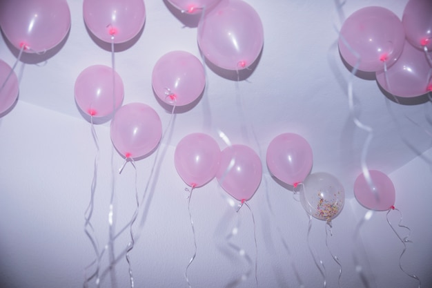 Pink Birthday Balloons With Streamers Touching The Ceiling