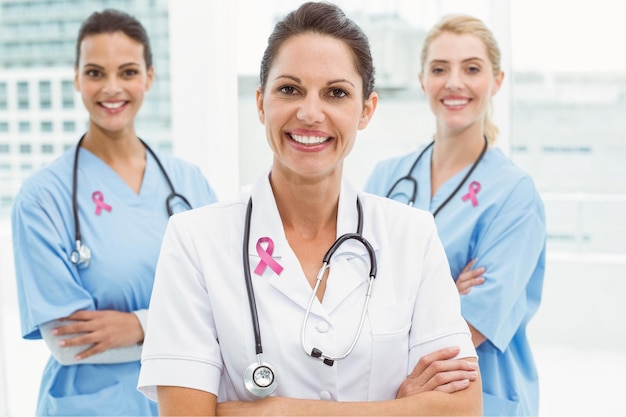 Premium Photo Pink Breast Cancer Awareness Ribbon Against Portrait Of Confident Female Doctors 2648