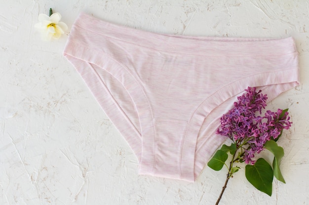 Premium Photo | Pink cotton panties with buds of daffodil flowers and ...