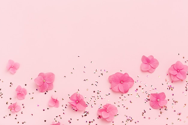 Pink flowers and glitter on a pink background | Premium Photo