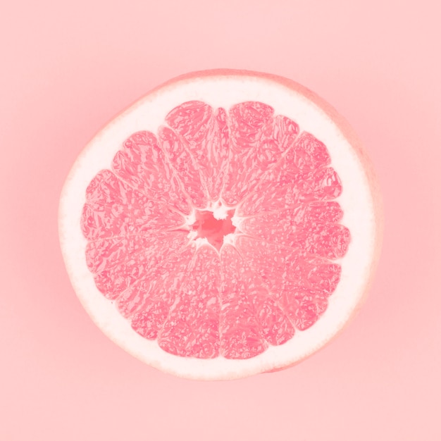 Free Photo | Pink halved fresh juicy grapefruit on pink background