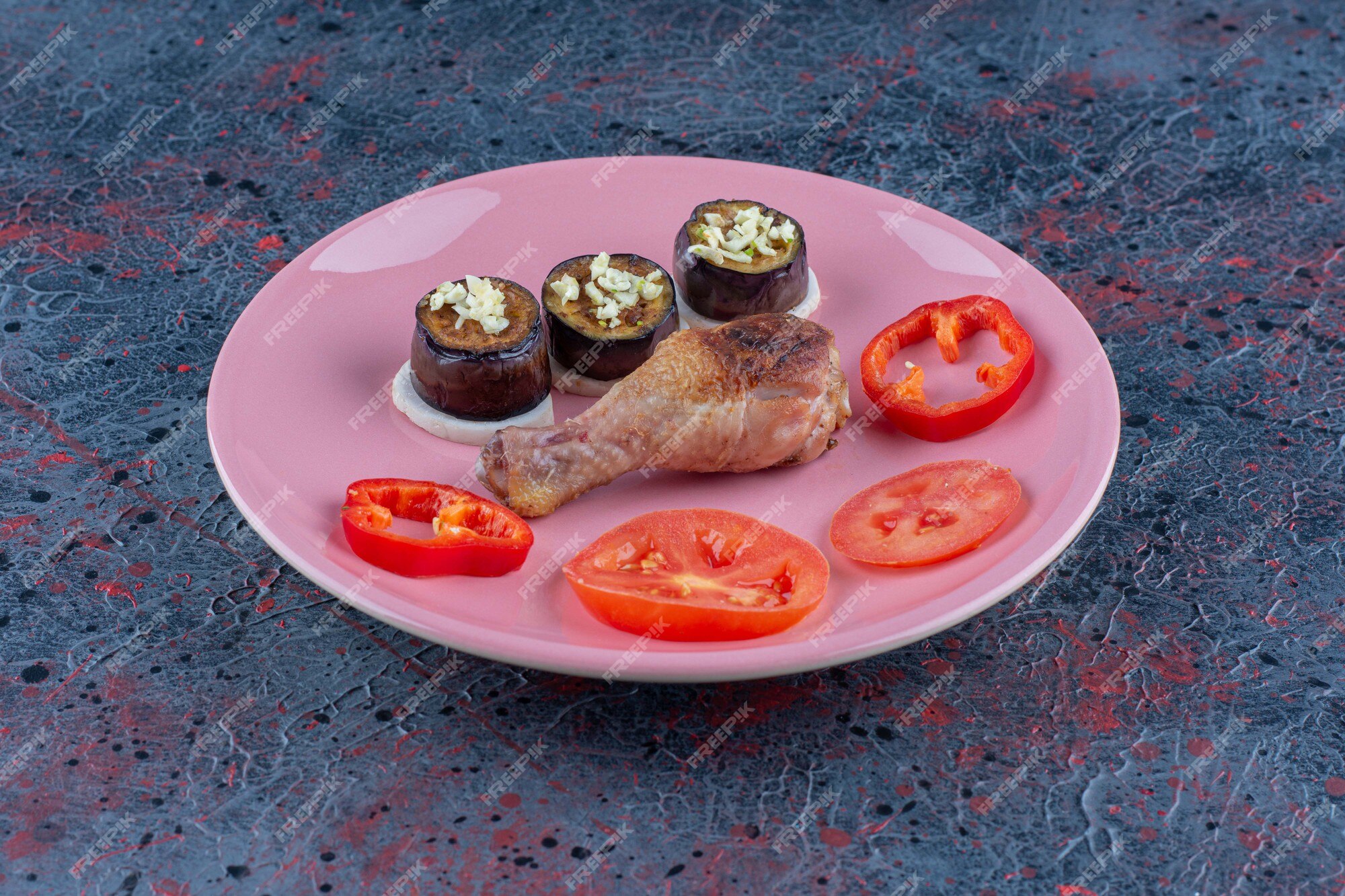 free-photo-a-pink-plate-of-chicken-leg-meat-with-sliced-vegetables