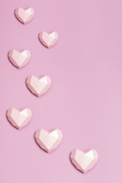 Premium Photo | Pink polygonal pink paper hearts