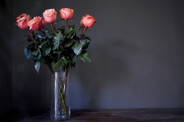 Pink Roses Flower Bouquet In A Clear Tall Crystal Vase Against A