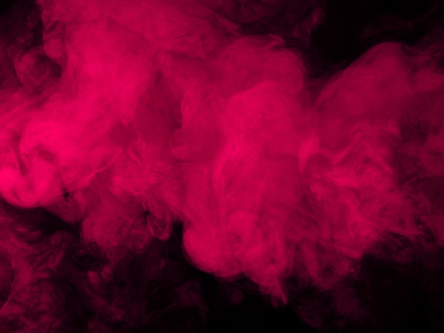 Premium Photo | Pink smoke on black background