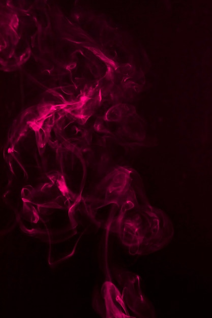 Free Photo | Pink smoke fragments on a black background