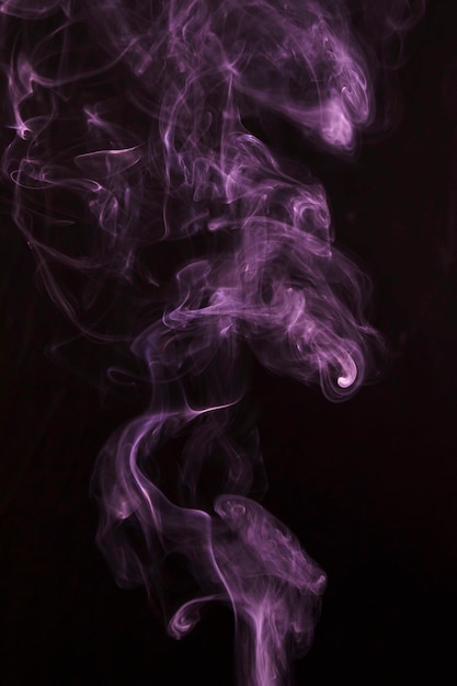 Free Photo | Pink smoke pattern spread over black background