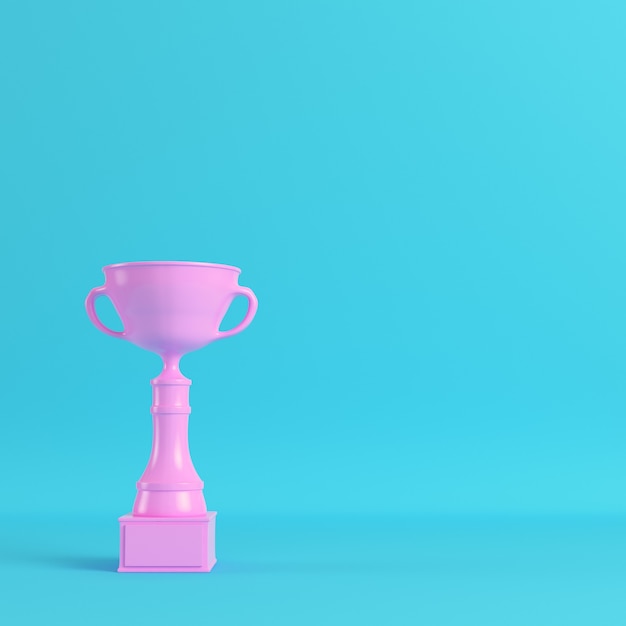 Premium Photo | Pink trophy cup on bright blue background