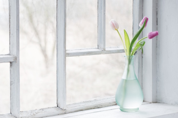 Premium Photo | Pink tulips on old white windowsill