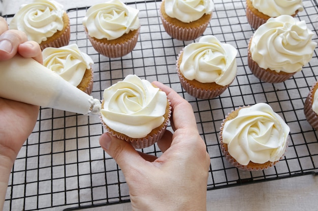 Premium Photo Piping Rose Flower Frosting On Vanilla Cupcakes