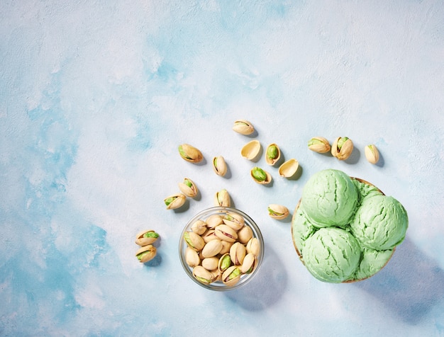 Download Premium Photo Pistachio Ice Cream In Paper Cup On On Background In Turquoise Table Top View