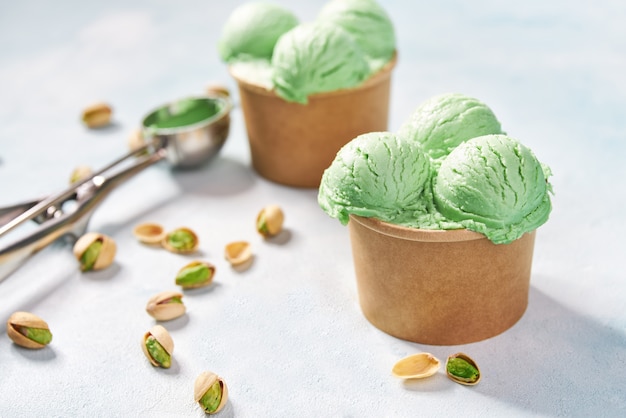 Download Premium Photo Pistachio Ice Cream In Paper Cup On Mint Colors Background Selective Focus PSD Mockup Templates