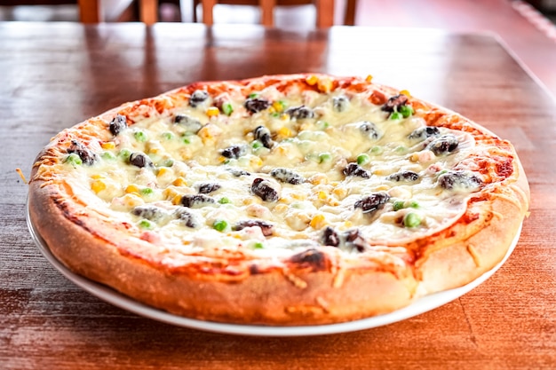 Premium Photo | Pizza on a restaurant table