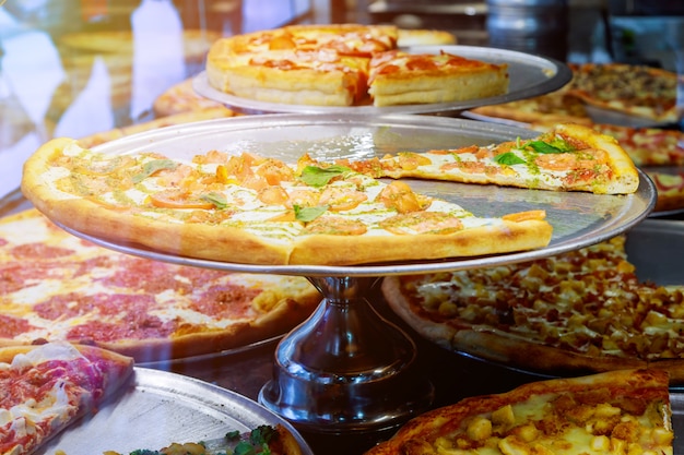 Premium Photo | Pizza resting on a pizzeria counter with sunlight ...