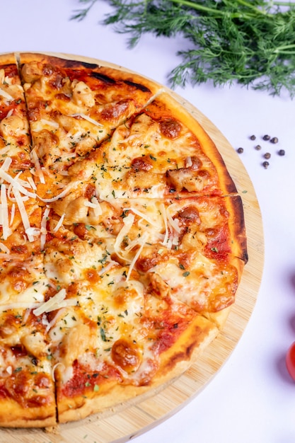 Pizza topped with extra cheese and herbs Free Photo