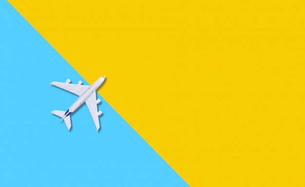 Premium Photo | Plane on a yellow background.