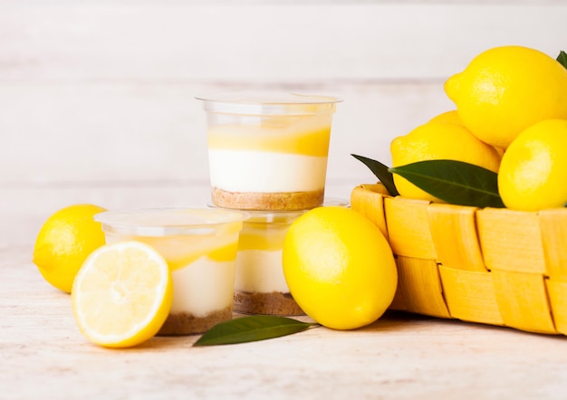 Plastic Cups With Lemon Cream And Biscuit Dessert Premium Photo