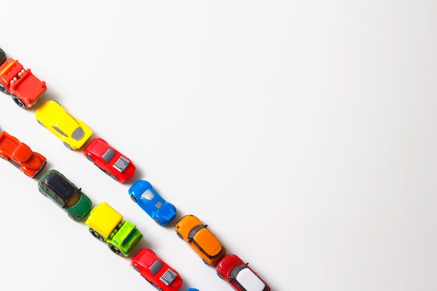 Premium Photo Plastic Multi Colored Toy Cars Are Lined Up On White