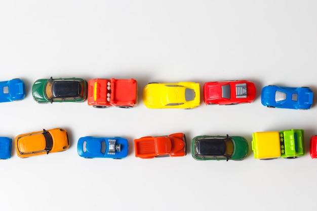 Premium Photo Plastic Multi Colored Toy Cars Are Lined Up On White