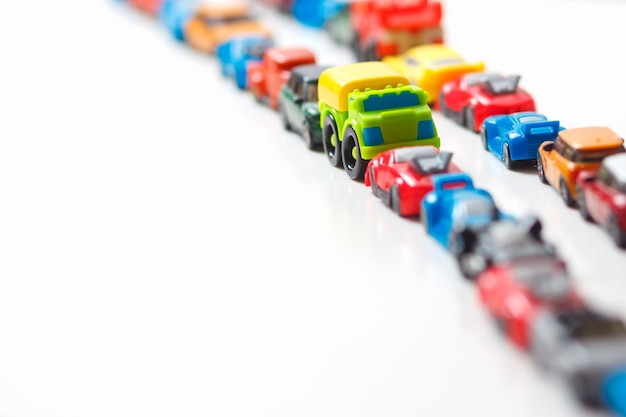 Premium Photo Plastic Multi Colored Toy Cars Are Lined Up On White