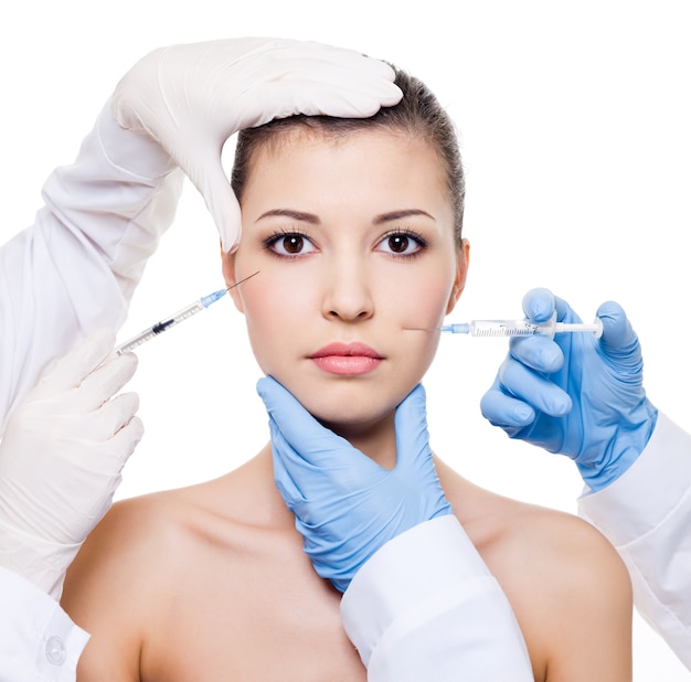 Free Photo Plastic surgeons giving botox injection in