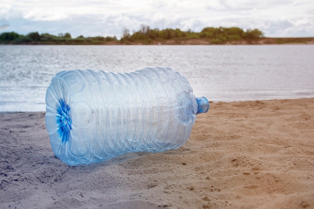 Premium Photo | Plastic waste - plastic bottles lying on the sand on ...