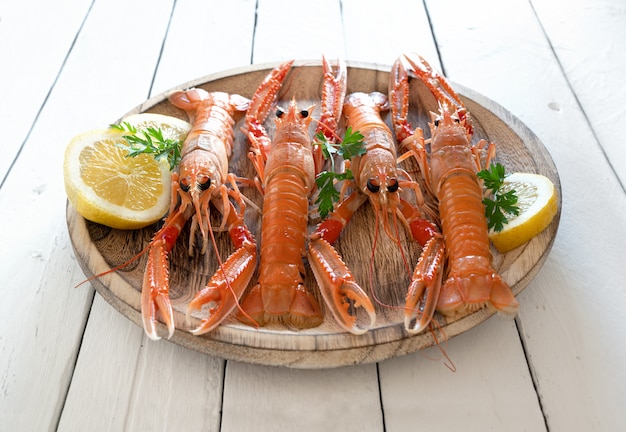 Premium Photo Plate Of Fresh Norway Lobsters On Rustic Background