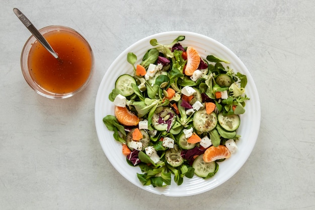 Free Photo | Plate with salad and bowl with souce