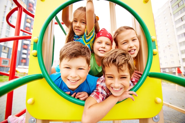 Playful classmates having fun on playground Free Photo