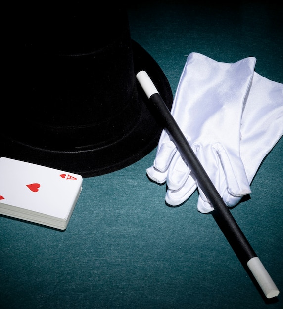 Free Photo | Playing cards; white gloves; top hat and magic wand on ...