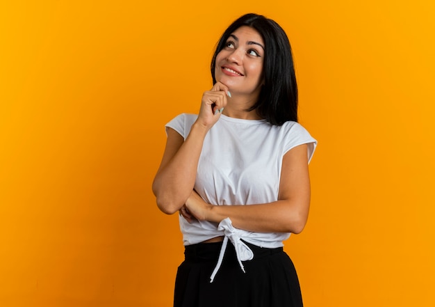 Free Photo Pleased Young Caucasian Girl Puts Hand On Chin Looking At Side