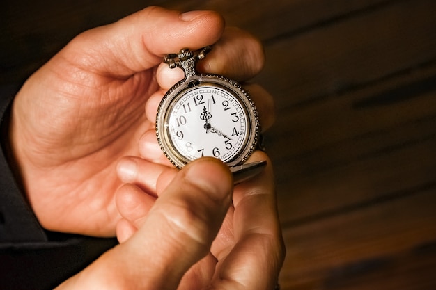 Premium Photo | A pocket watch in the hands of a man