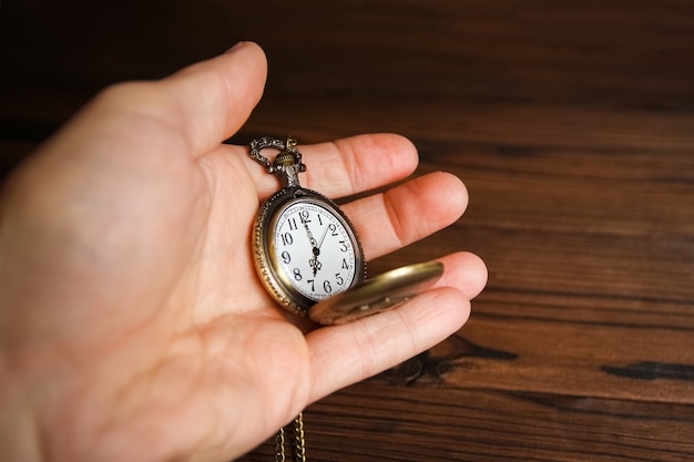 Premium Photo | A pocket watch in the hands of a man