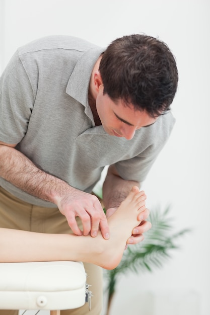 Premium Photo | Podiatrist Examining The Foot Of A Patient