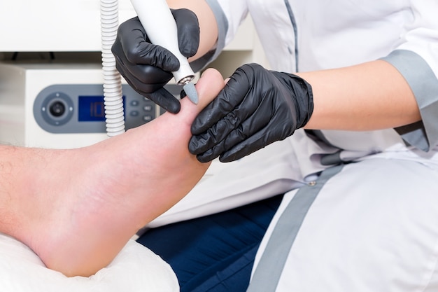 Premium Photo | Podiatry doctor treats the patient in modern clinic